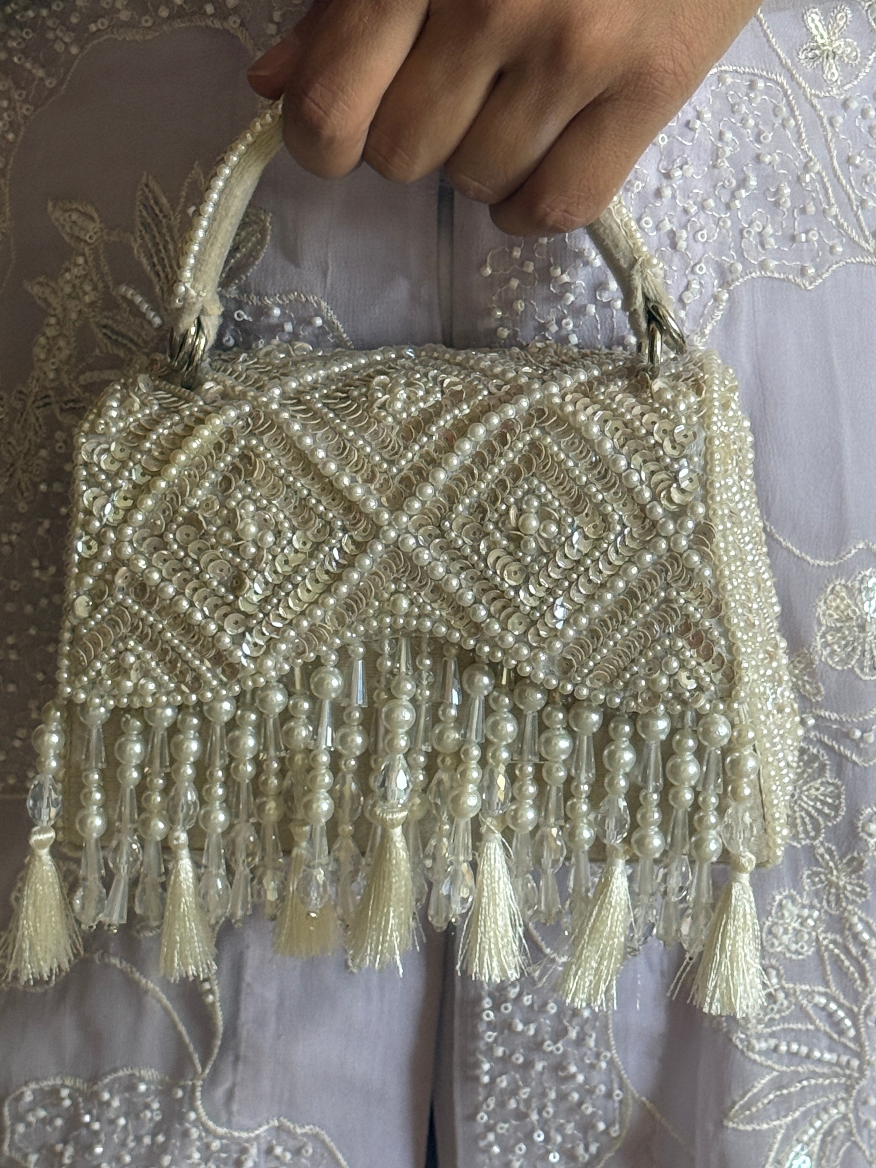 Handcrafted pearl festive bag combining artisanal craftsmanship with timeless elegance