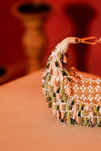 Green embellished party handbag with intricate artisanal beadwork