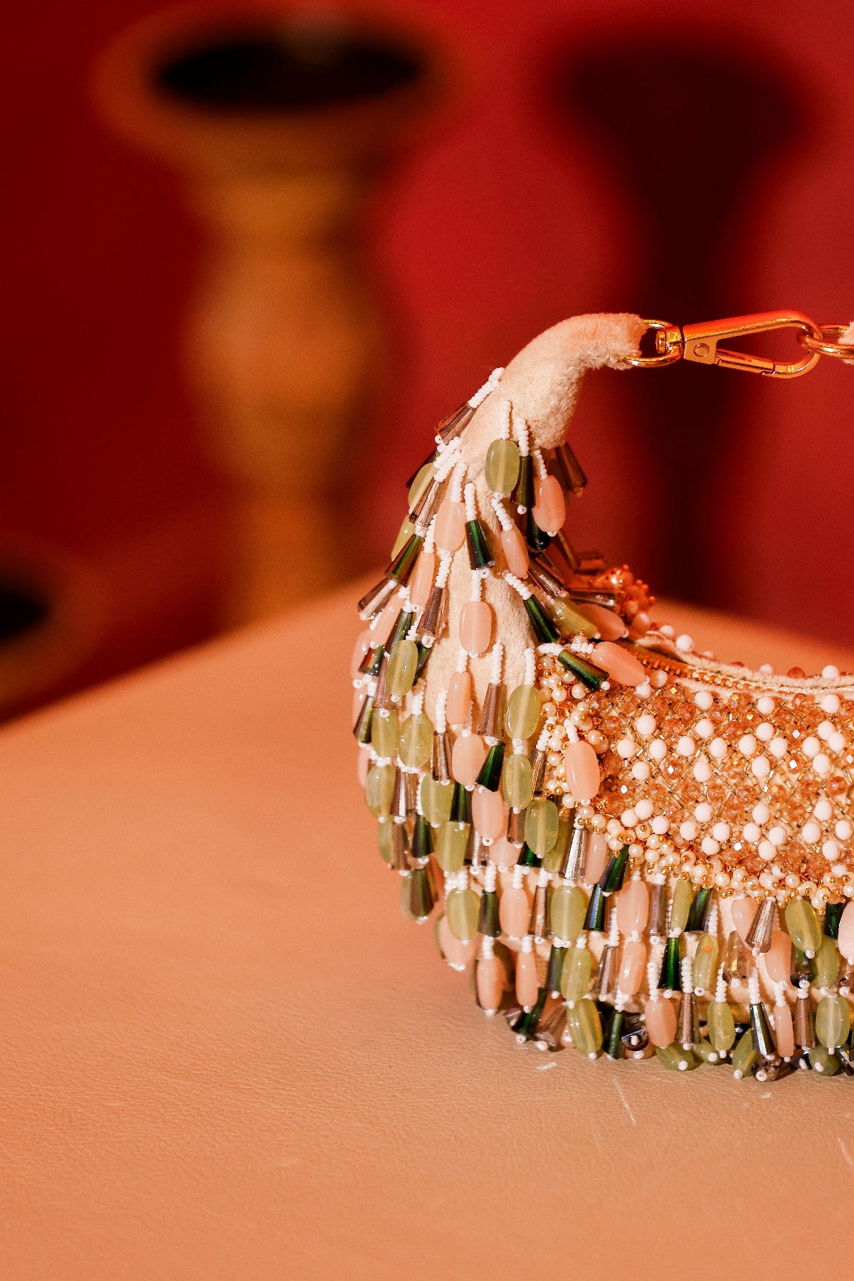 Green embellished party handbag with intricate artisanal beadwork