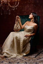 Gold festive handbag with statement mirror accents and elegant bead tassels