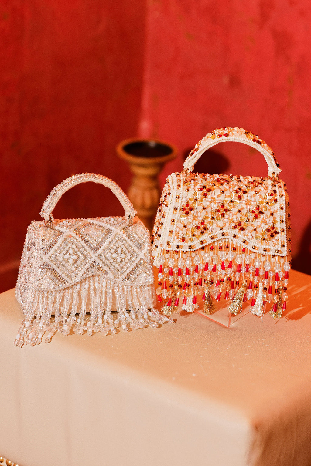Statement ethnic occasion handbag with intricate stone embroidery and tassel accents