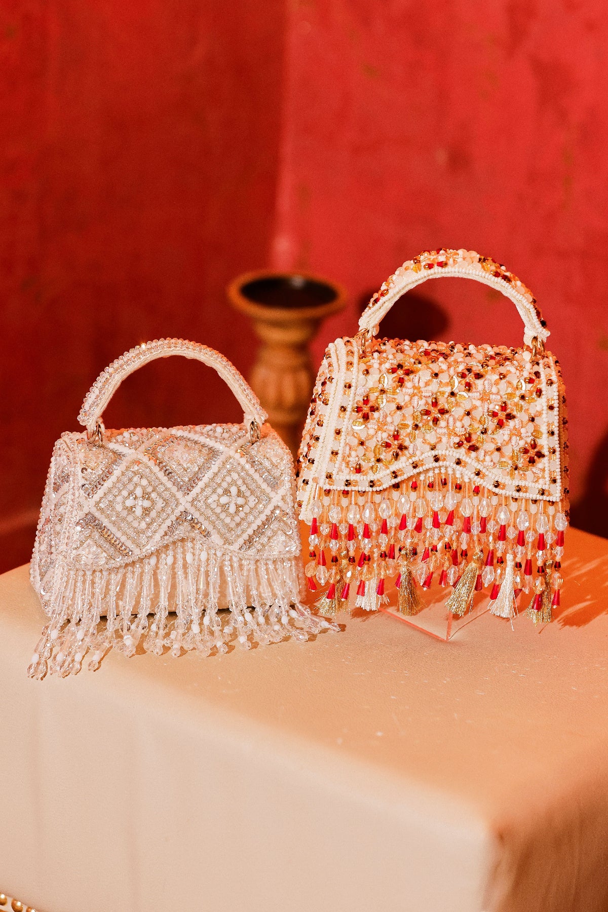 Statement ethnic occasion handbag with intricate stone embroidery and tassel accents