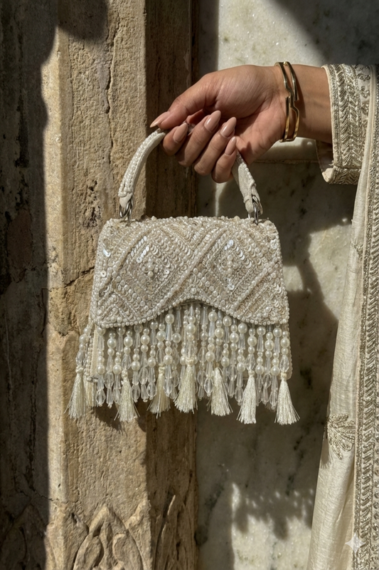 Ivory beaded evening purse inspired by glamorous celebrations and festive styling