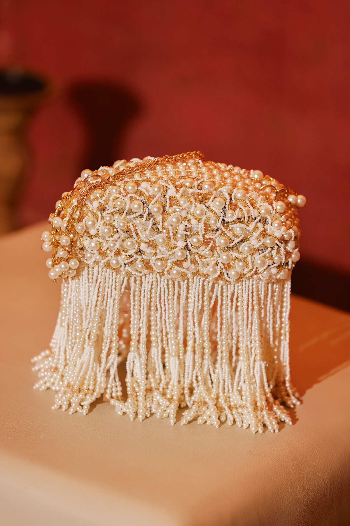 Ivory bridal occasion bag with statement pearl detailing and elegant handcrafted texture