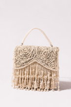 Ivory beaded party handbag inspired by glamorous celebrations and festive evening styling