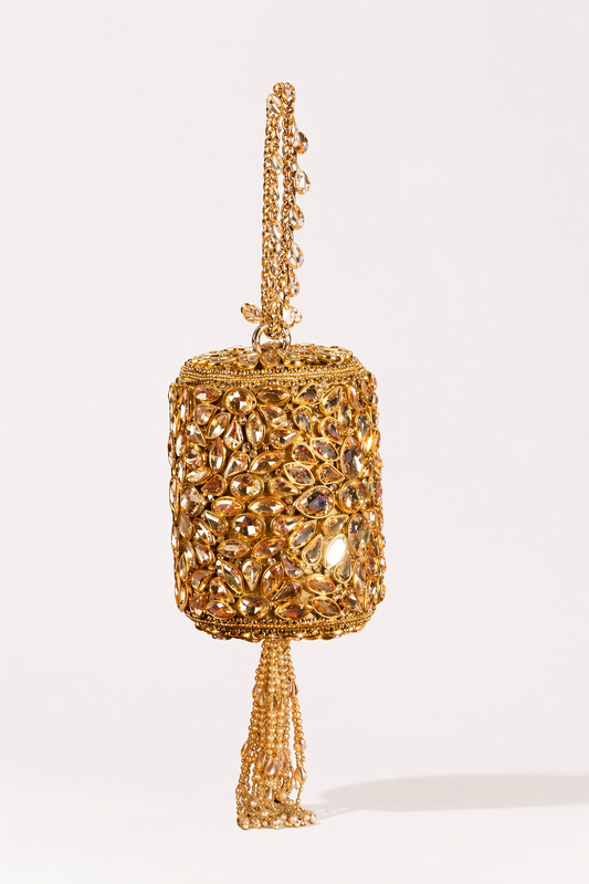 Kundan bridal potli bag with intricate gold embellishments and elegant tassel detailing