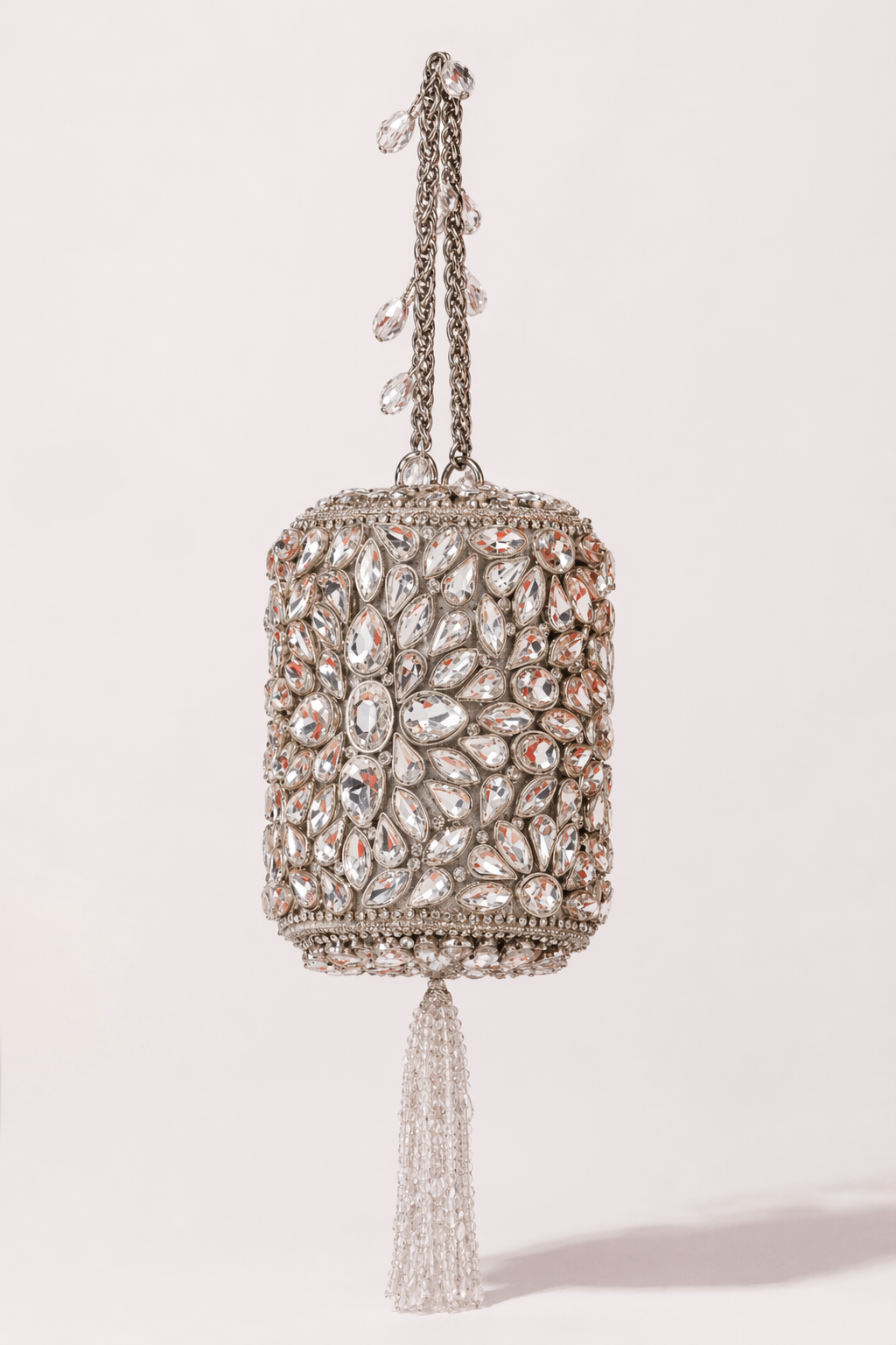 Kundan silver bag with intricate stone embellishments and elegant tassel detailing