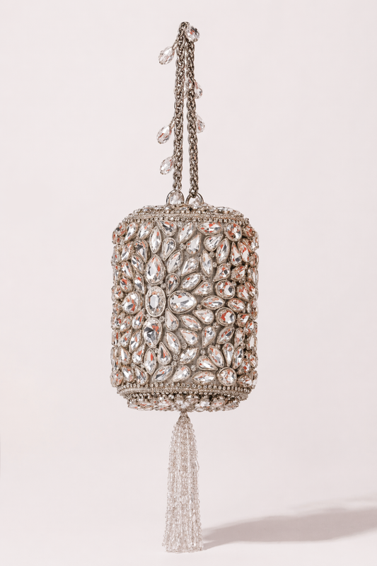 Kundan silver bag with intricate stone embellishments and elegant tassel detailing