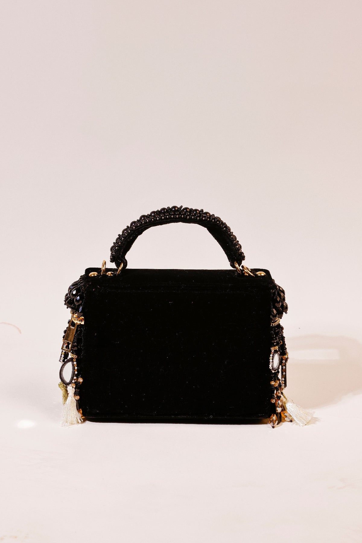 Festive black box bag featuring handcrafted beadwork and reflective mirror