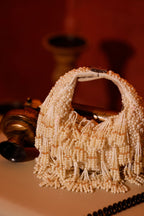 Statement shoulder purse featuring layered beadwork and artisanal craftsmanship