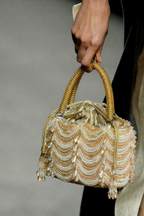 Luxury gold wedding guest bag featuring layered pearl embellishments and elegant texture