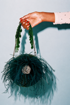 Luxury green feather purse featuring handcrafted detailing and statement party appeal