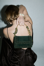 Luxury green party purse featuring handcrafted stone embellishments and rich texture