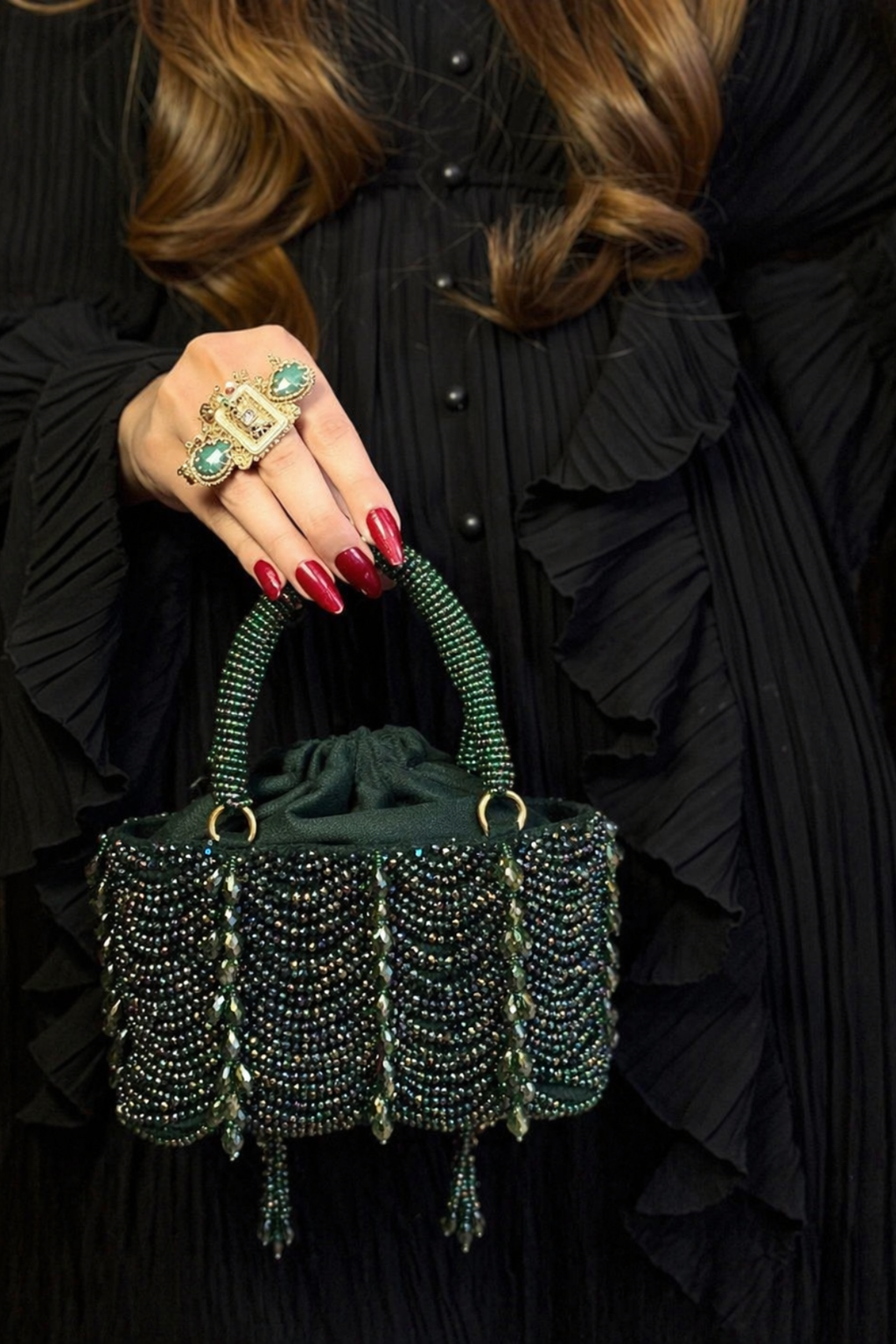 Luxury green wedding guest bag featuring intricate beadwork and handcrafted texture