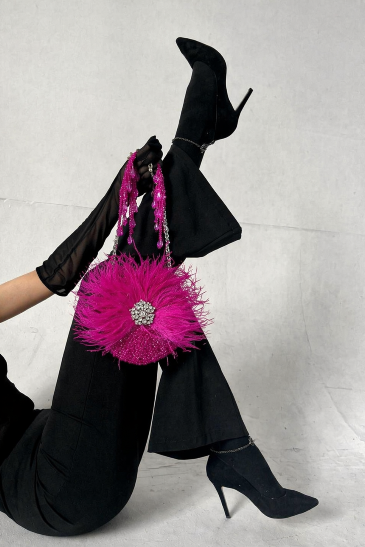 Luxury pink feather bag featuring handcrafted sparkle and statement festive detailing