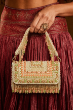 Pastel wedding guest bag featuring handcrafted detailing and statement tassel accents