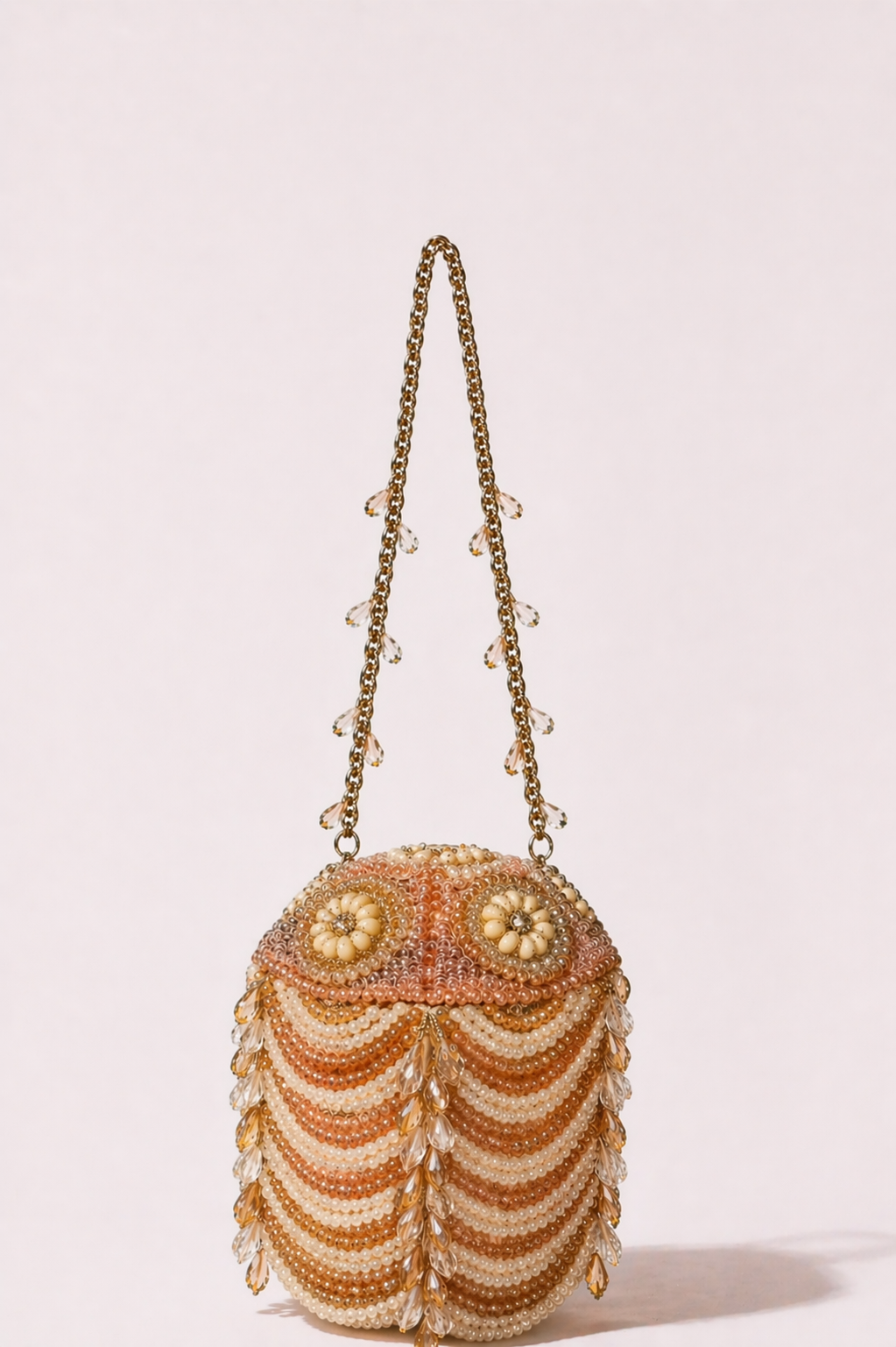 Luxury peach pearl embellished evening bag with crystal detailing and statement handle