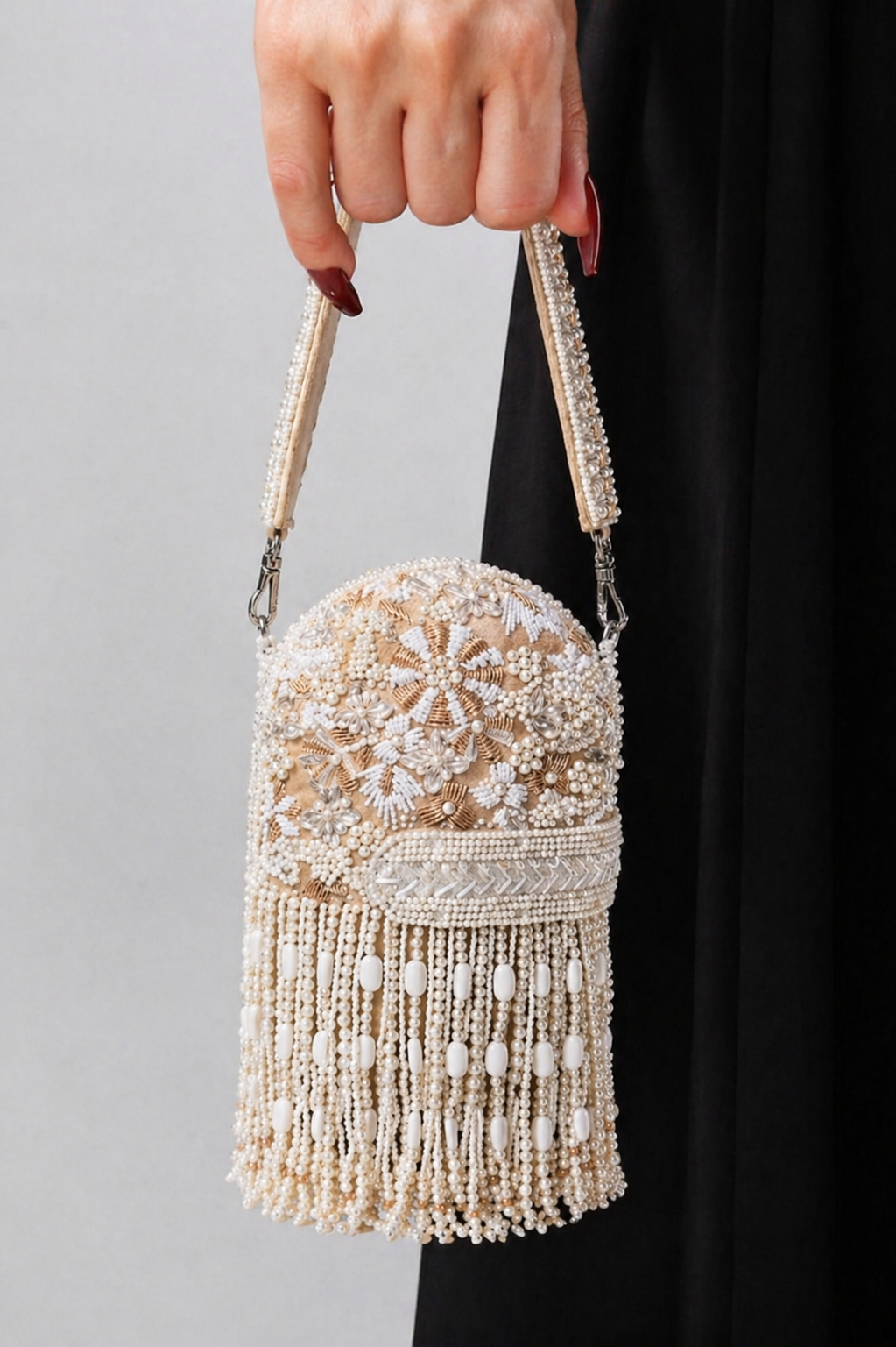 Pearl embellished shoulder bag featuring cascading tassels and intricate embroidery