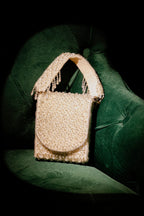 Pearl white sling bag featuring handcrafted beadwork