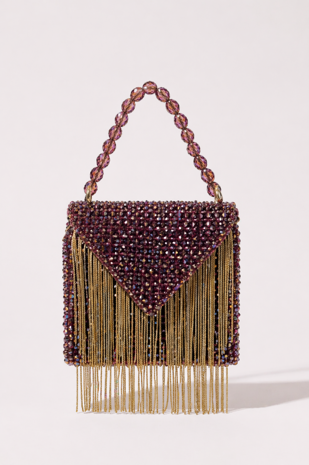 Pink toned beaded sling bag with metallic fringe and shimmering crystal accents