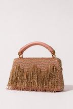 Pink embellished party handbag with elegant fringe detailing and handcrafted festive texture