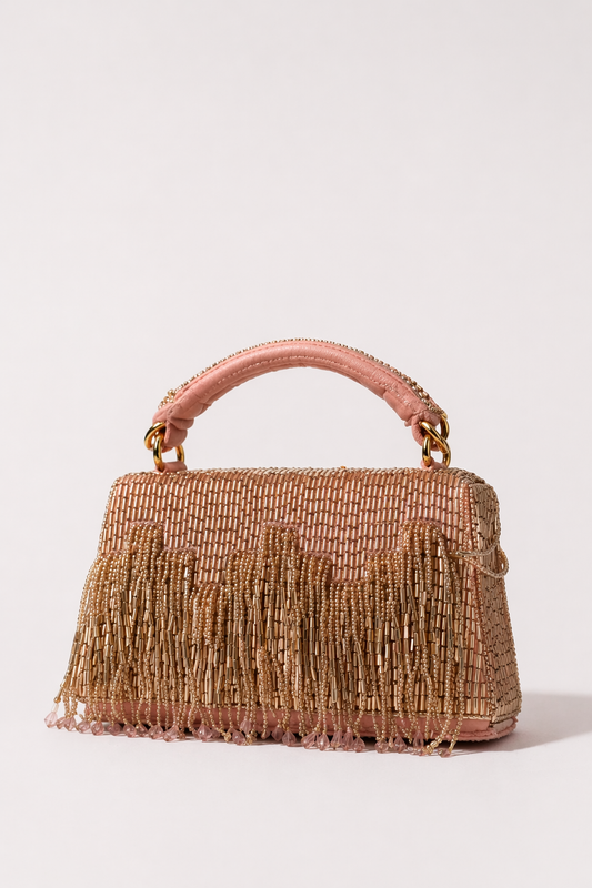 Pink embellished party handbag with elegant fringe detailing and handcrafted festive texture