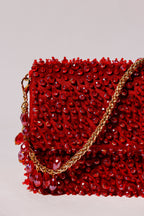 Chain handle evening purse inspired by celebration dressing and night-out fashion