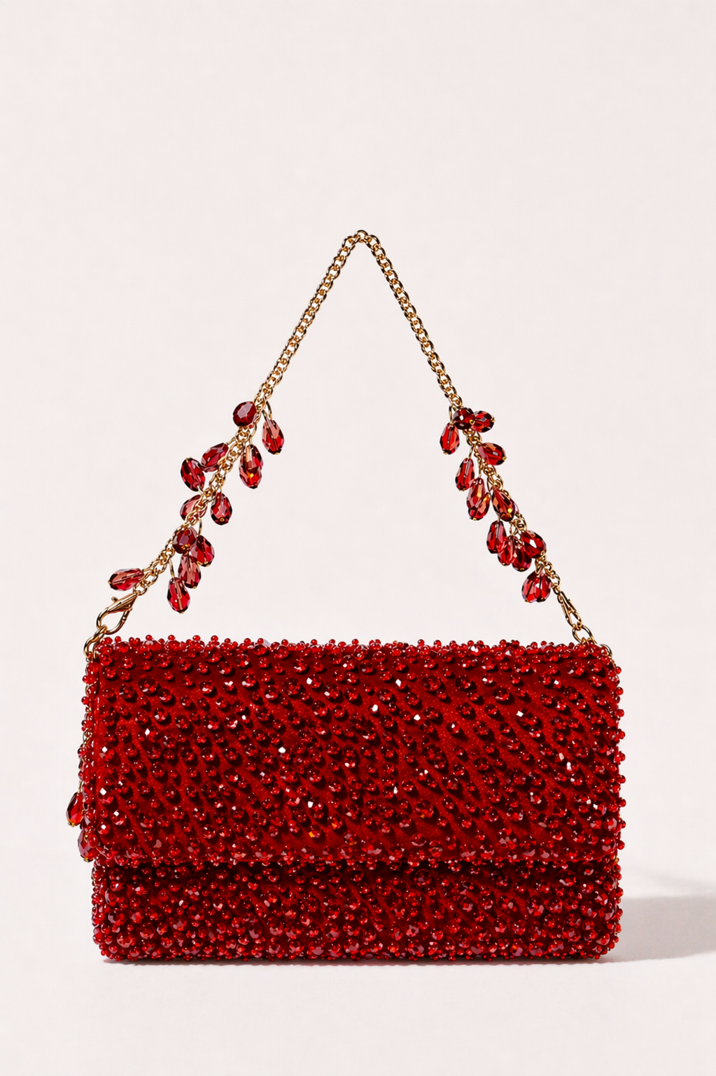 Ruby red crystal handbag with radiant embellishments and jewel-inspired chain detailing
