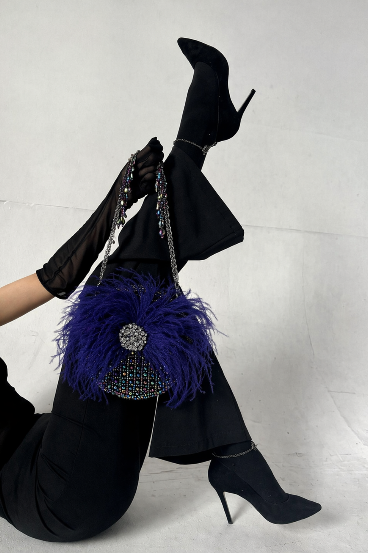Feather detailed party bag featuring sparkling beadwork and statement styling