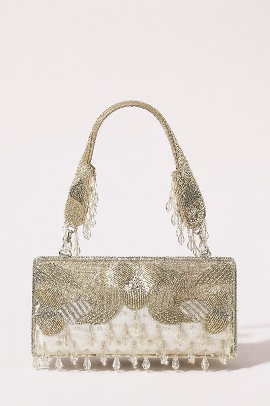 Silver beaded evening handbag with crystal tassel detailing and festive shimmer