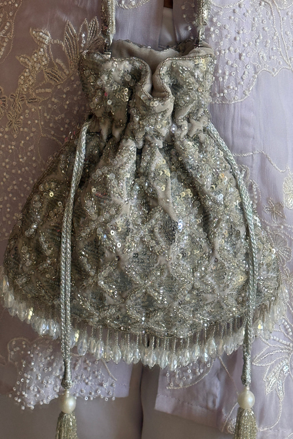 Silver beaded festive bag designed beautifully for receptions and celebration dressing