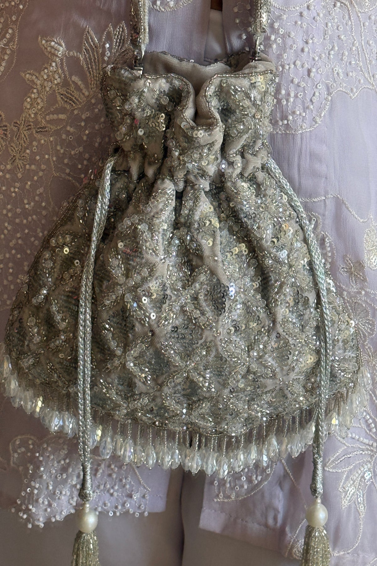 Silver beaded festive bag designed beautifully for receptions and celebration dressing