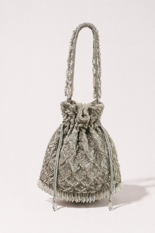 Silver bridal potli bag with intricate embroidery and handcrafted festive detailing