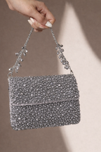 Cocktail-ready occasion bag featuring intricate crystal texture and metallic shine
