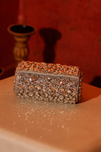 Occasion wear shoulder bag featuring detailed crystal work and metallic accents