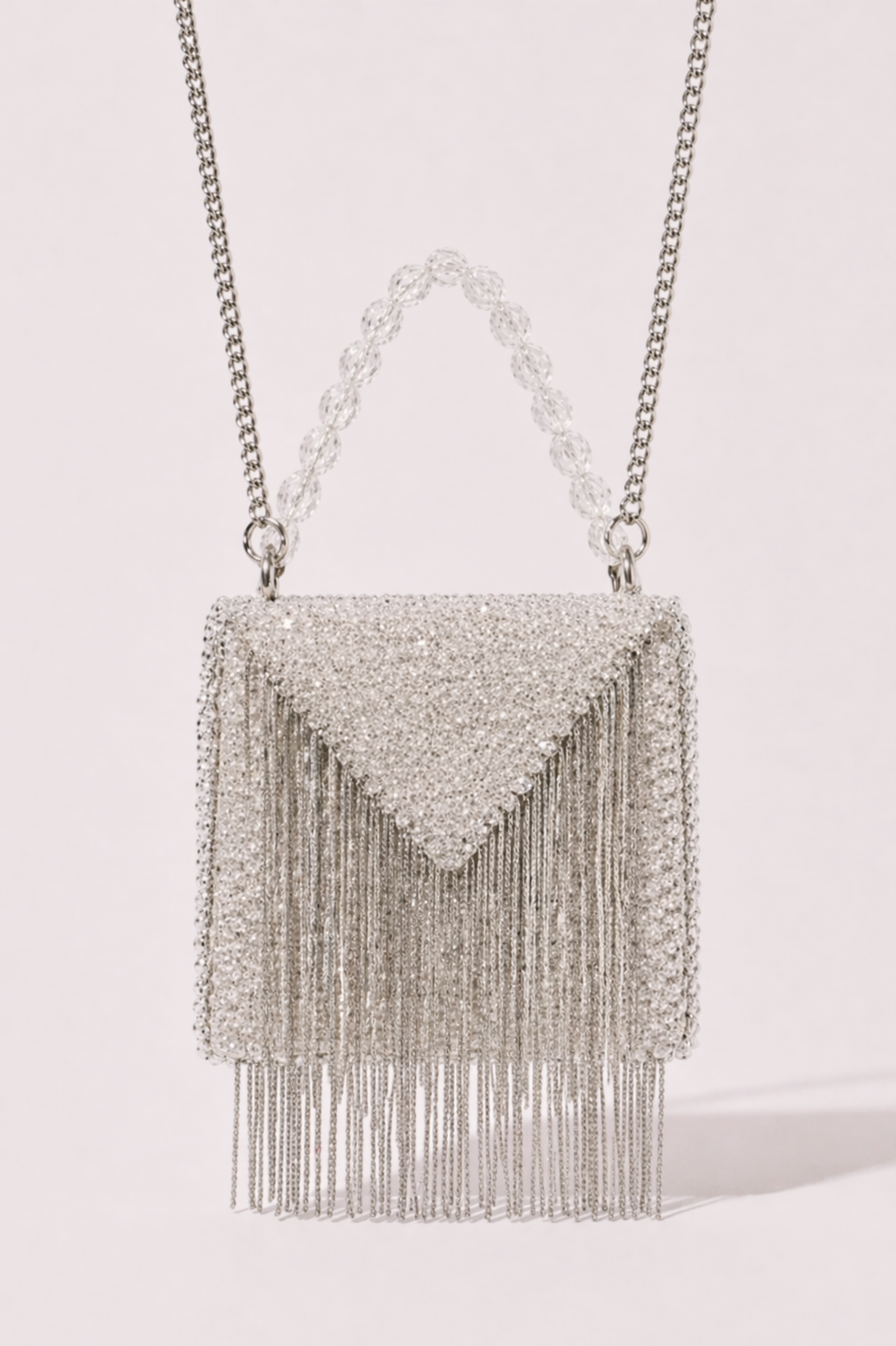 Silver fringe sling bag with shimmering crystal detailing and sleek metallic chains