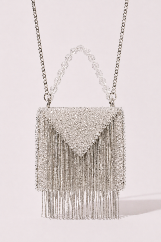 Silver fringe sling bag with shimmering crystal detailing and sleek metallic chains