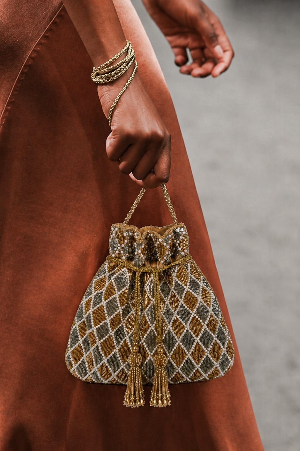 Silver gold designer purse featuring intricate beadwork and statement festive sparkle