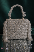Silver sangeet occasion purse featuring handcrafted texture and statement fringe accents