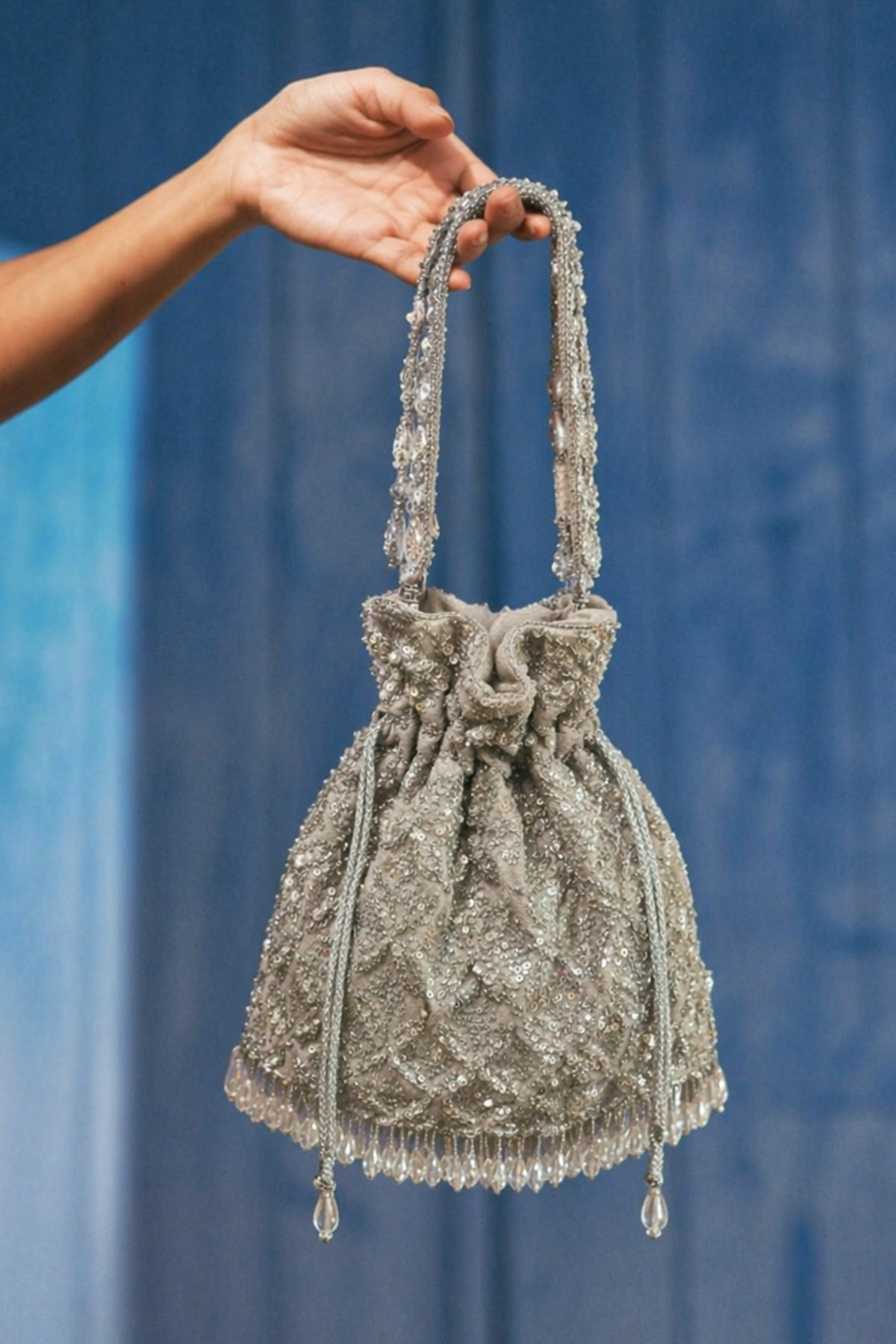 Silver traditional drawstring handbag inspired by wedding celebrations and elegant glamour