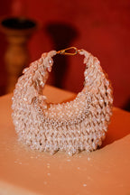 Trousseau-inspired party bag with reflective crystal detailing and bold silhouette
