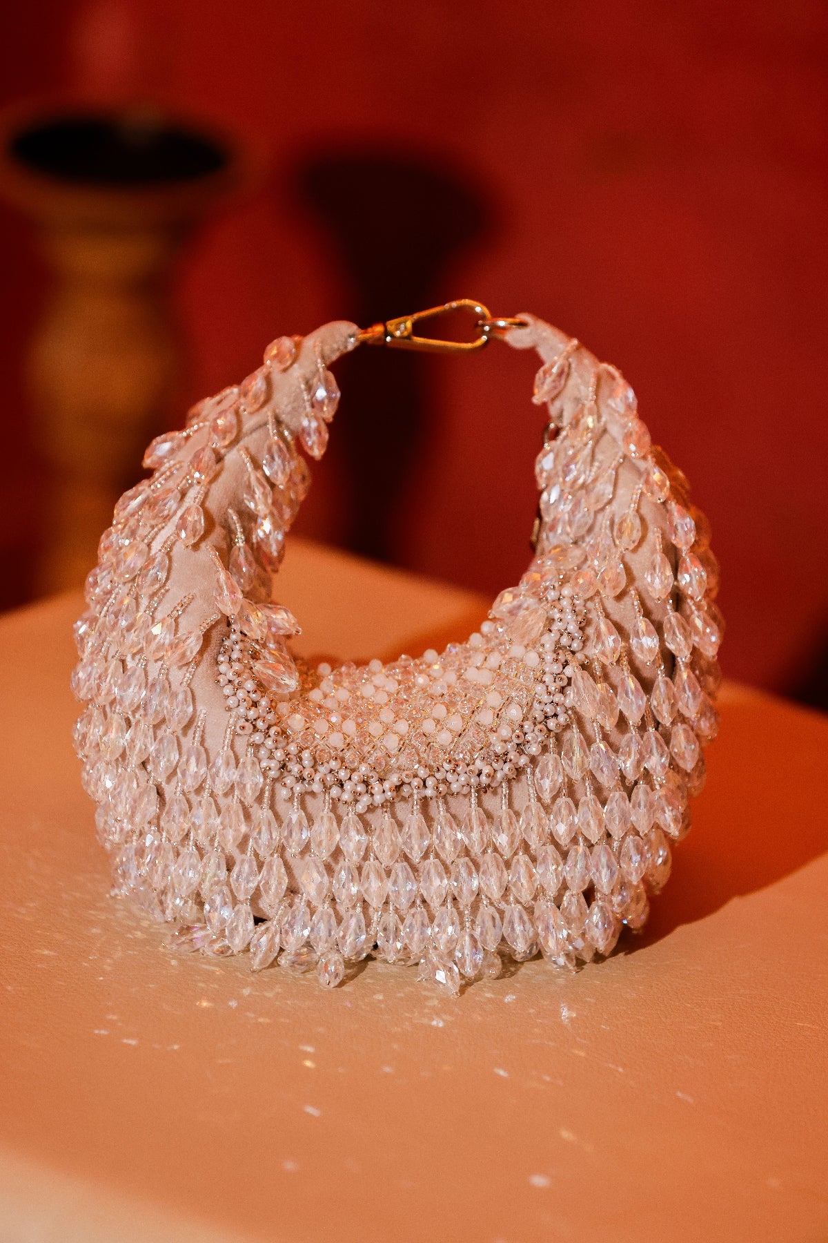 Trousseau-inspired party bag with reflective crystal detailing and bold silhouette