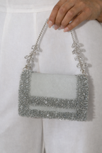Luxury silver wedding guest purse featuring handcrafted stone embellishments and sleek texture