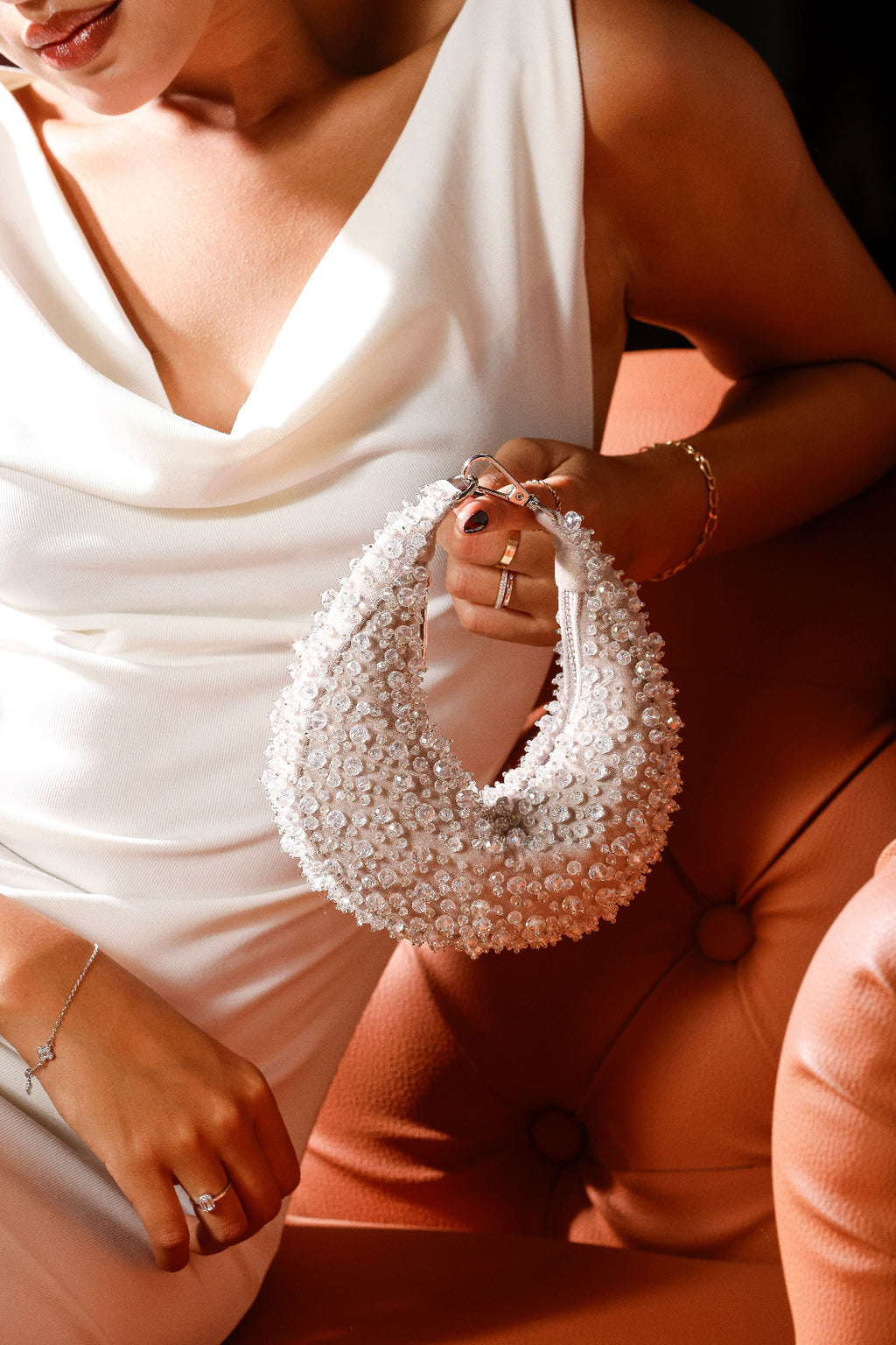 Handcrafted pearl mini bag featuring intricate crystal detailing and soft ivory tones