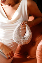 Handcrafted pearl mini bag featuring intricate crystal detailing and soft ivory tones