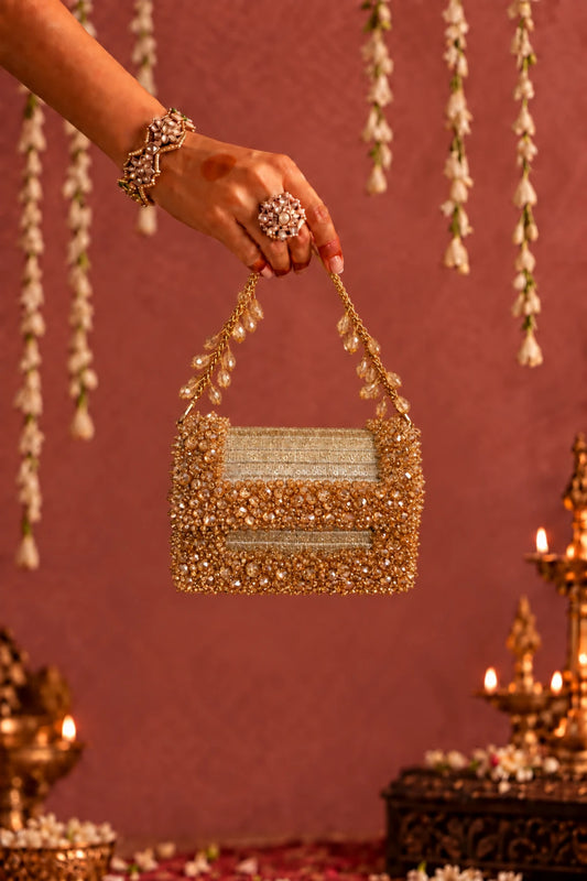 Kashvi Golden Mini Bag featuring intricate golden bead embellishments and a shimmering fabric base, perfect for gifting.