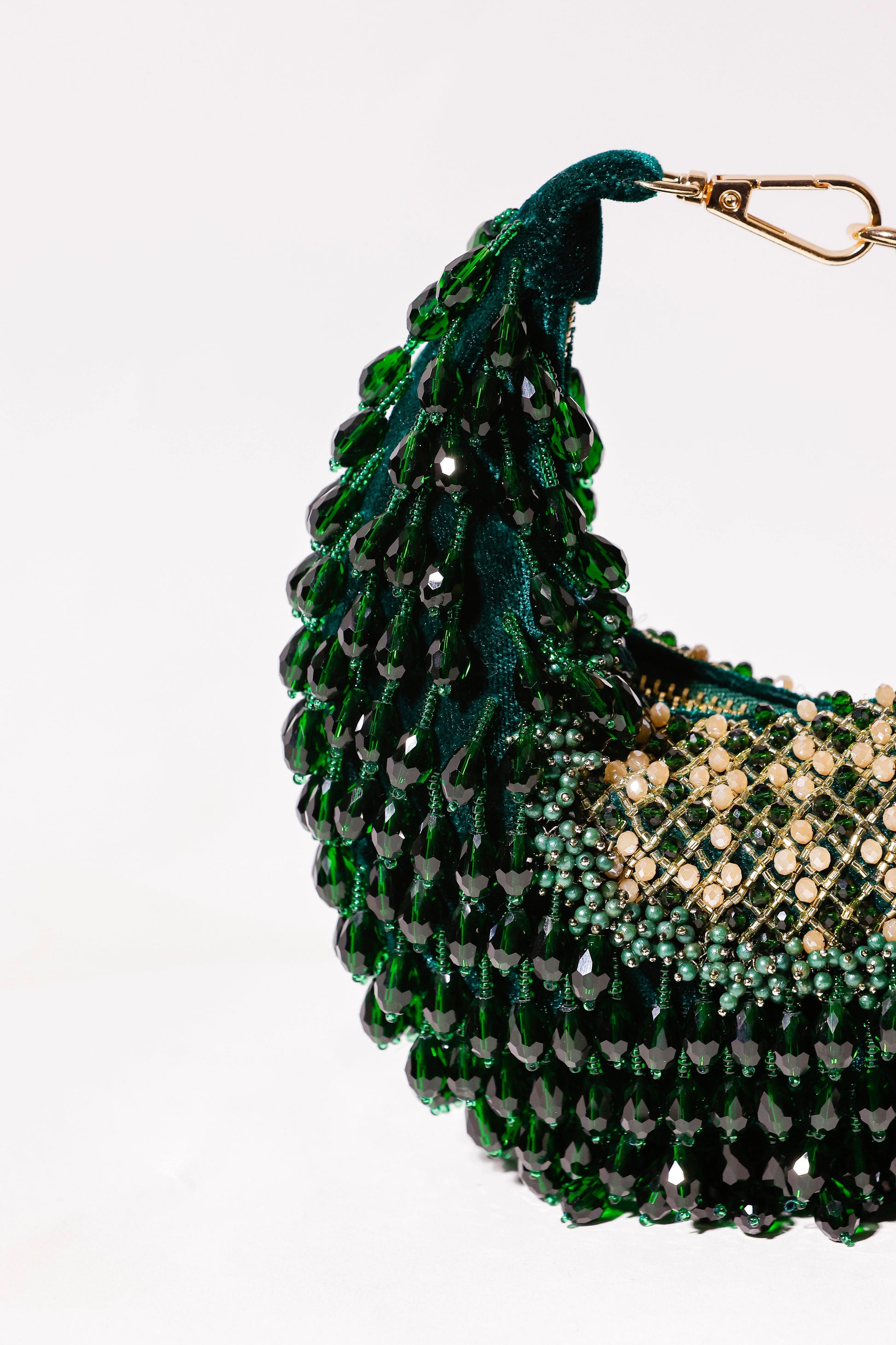 Luxury green hobo bag paired with a festive saree