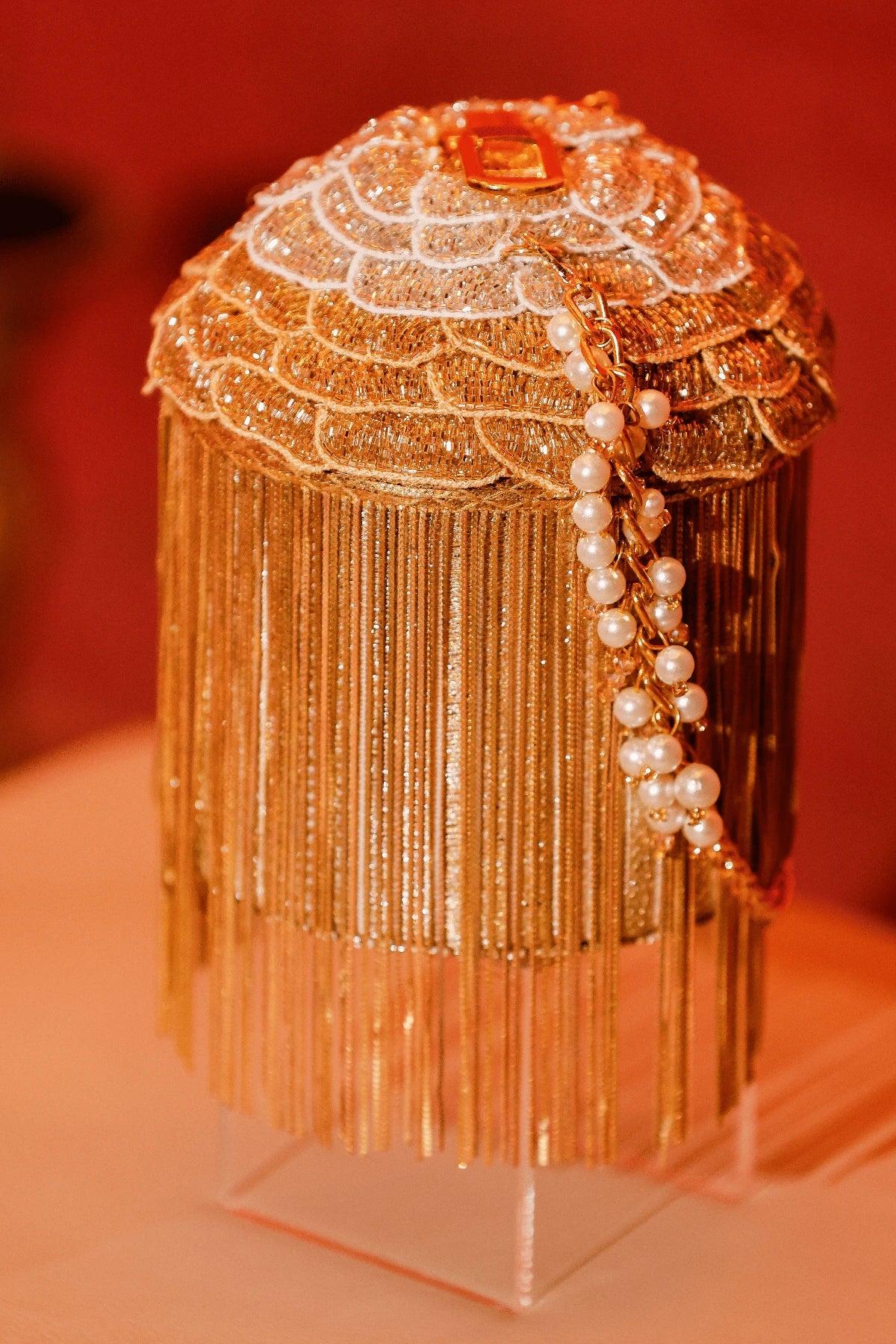Luxury golden bucket bag with statement fringe detailing