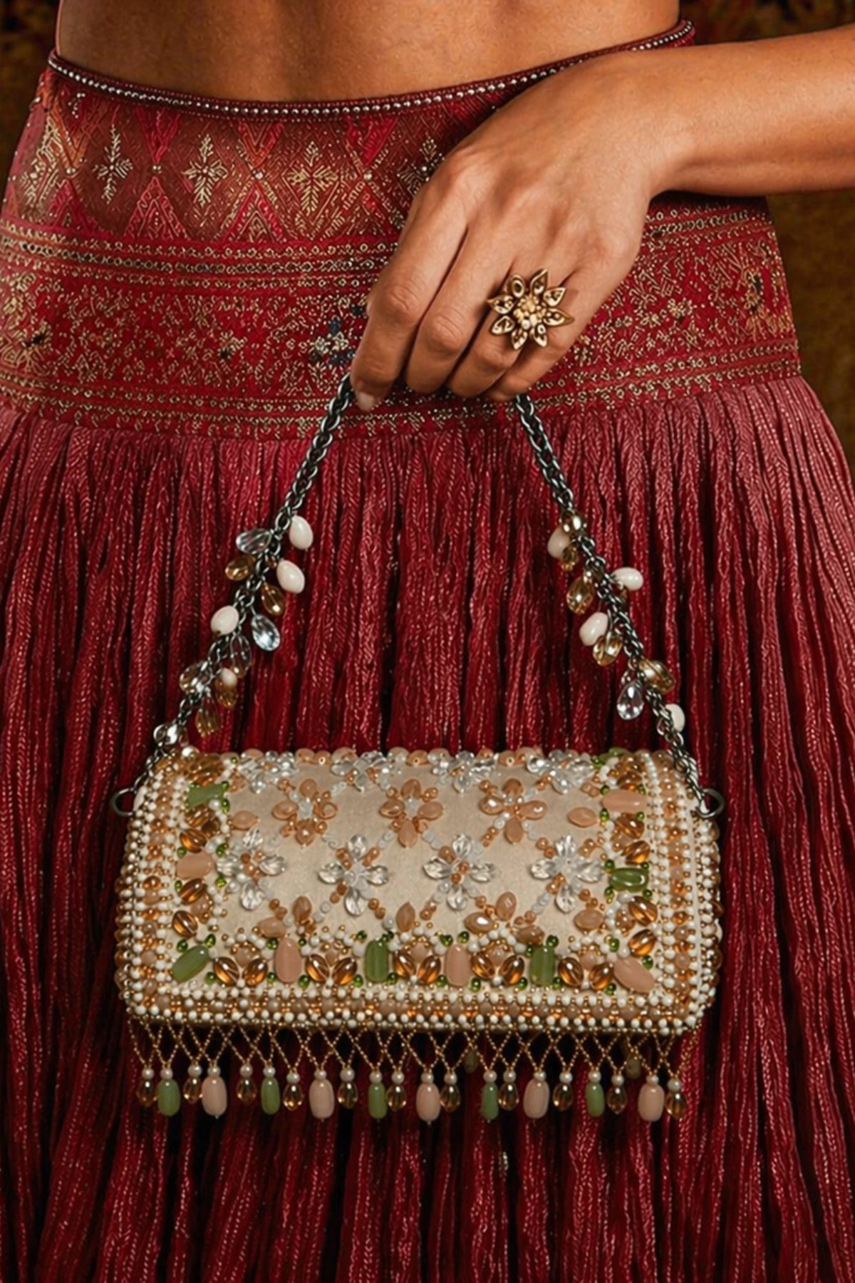 Luxury pearl embellished clutch paired with a festive saree