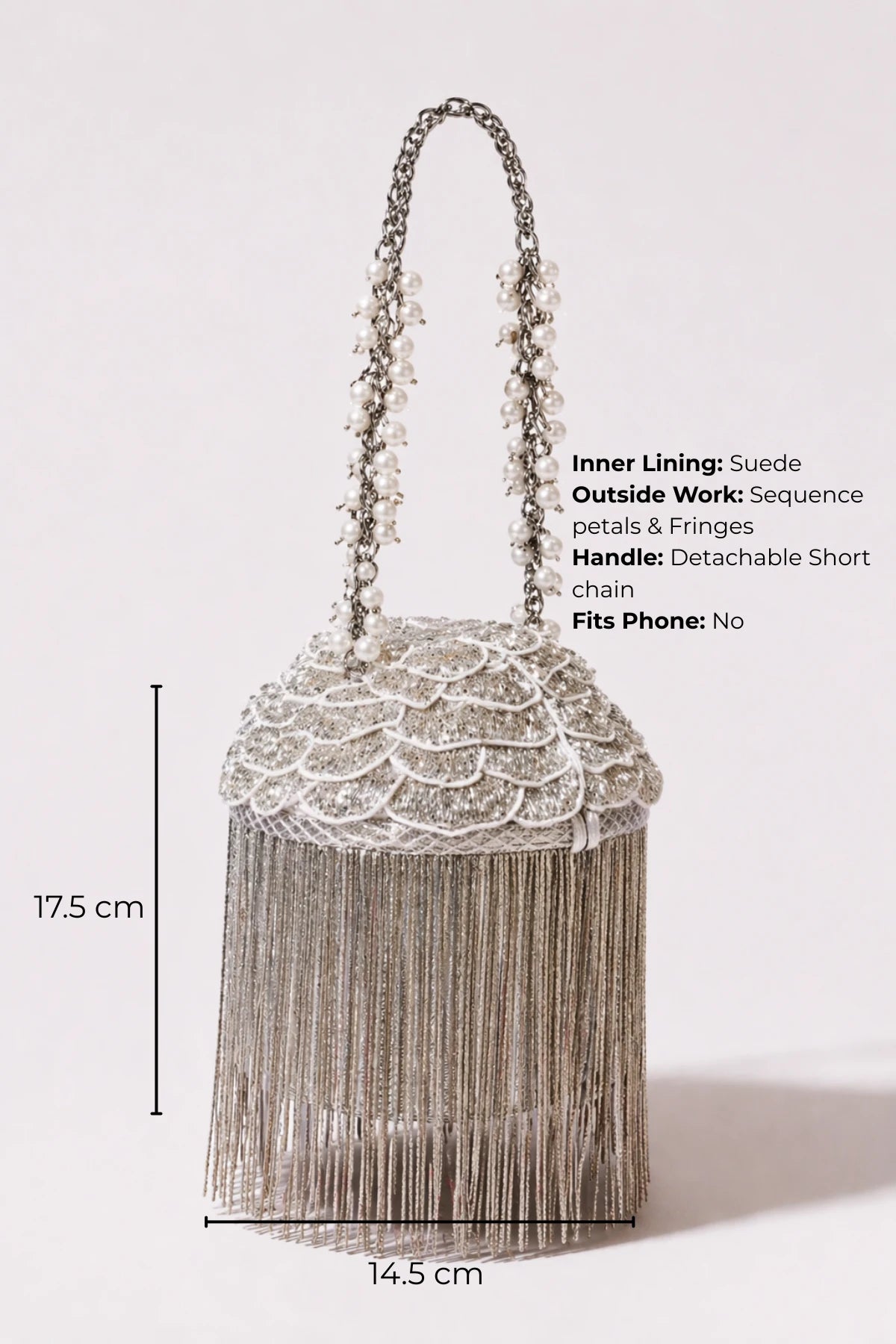 Luxury silver bucket bag paired with a festive saree